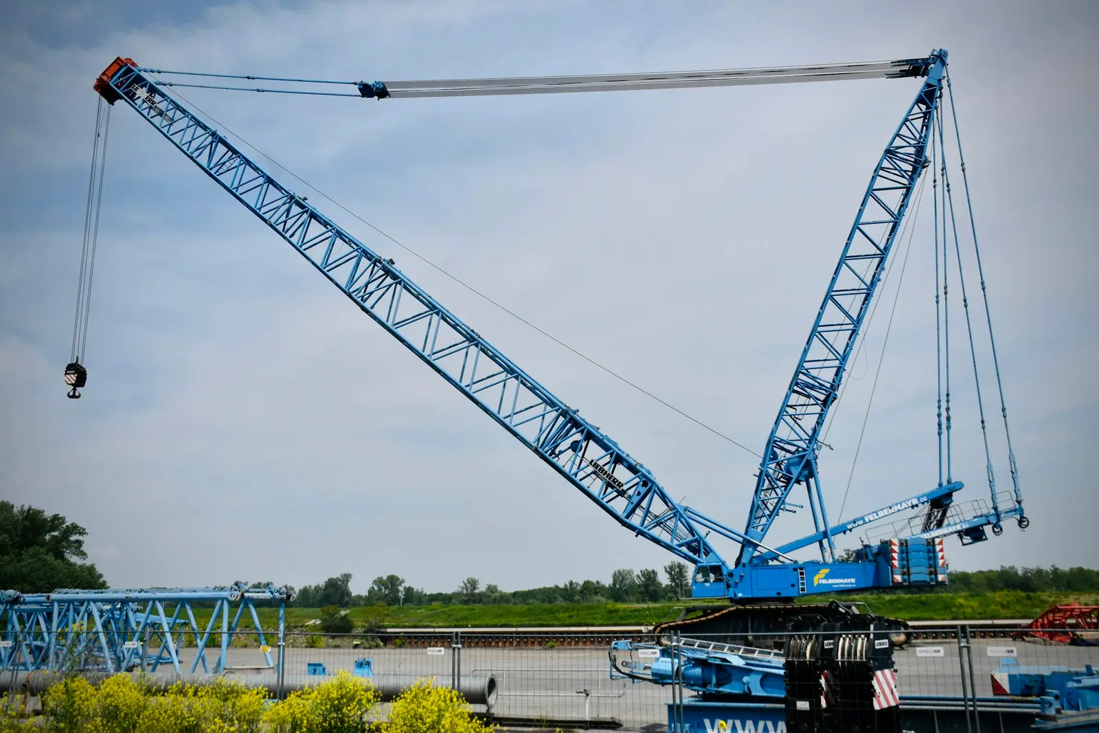 Lattice boom crawler crane at a project site