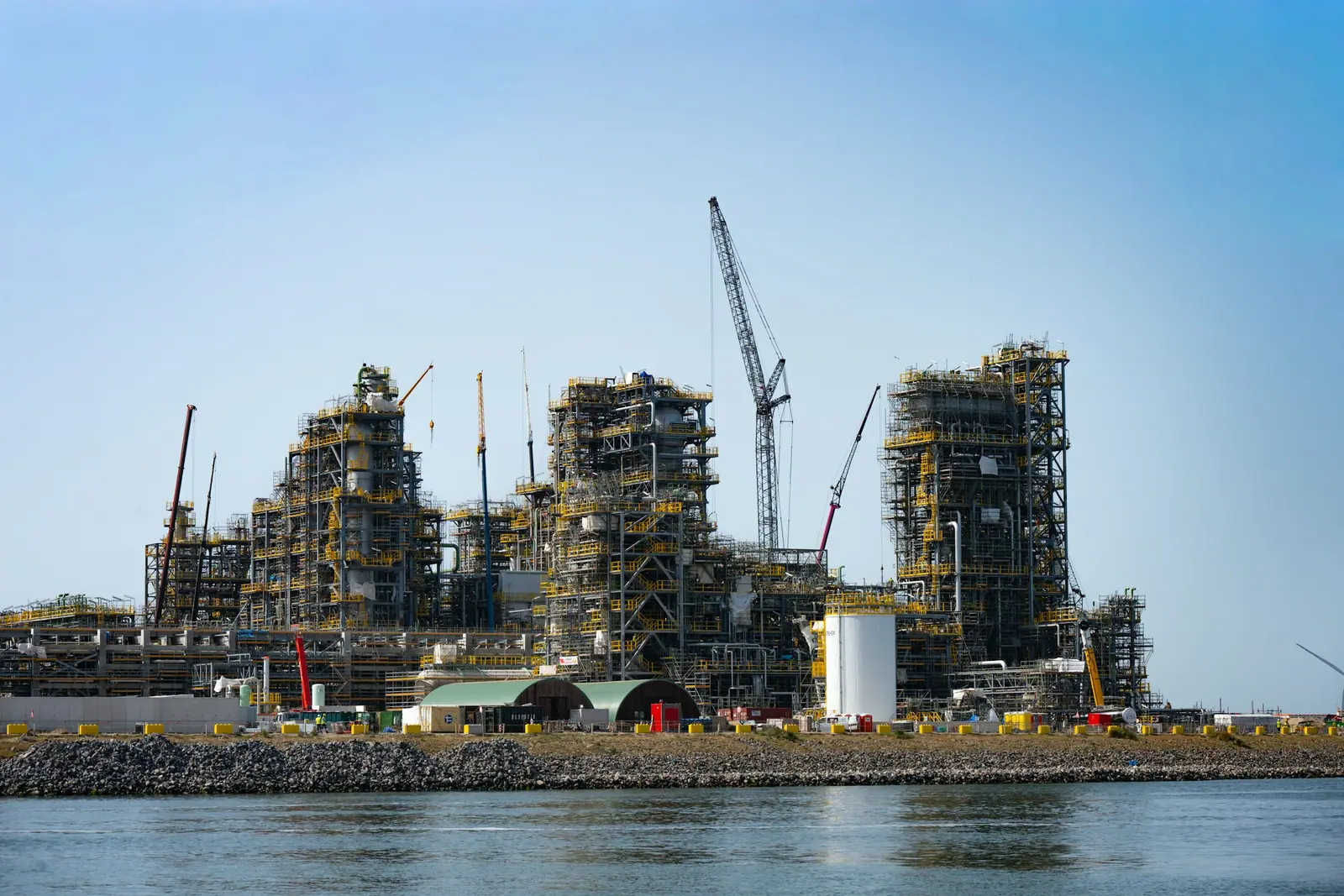 Industrial plant under construction with cranes on site